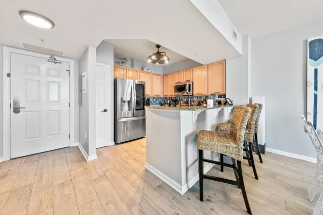 a kitchen with granite countertop a sink and cabinets