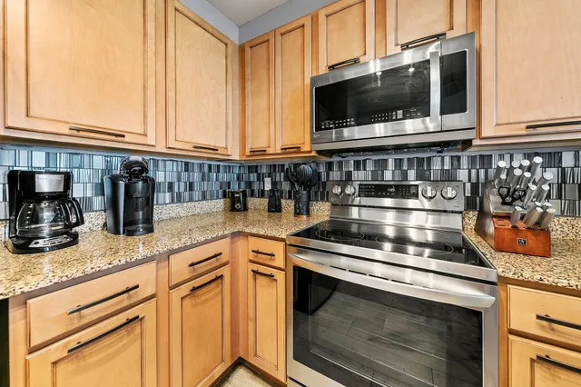 a living room with furniture a ceiling fan and a rug
