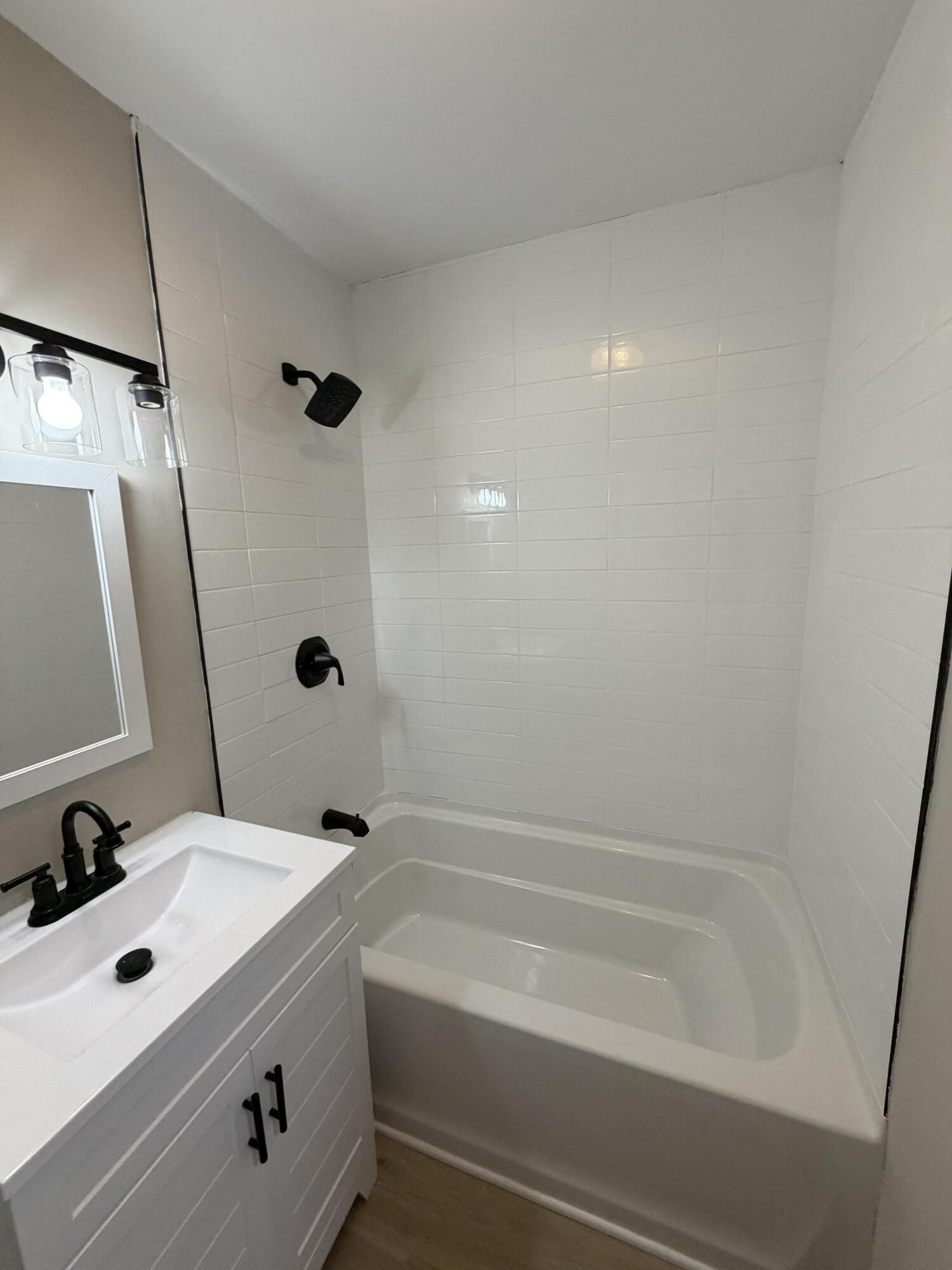 603 West 13th Street La Porte, IN 46350 - Photo 11 of 18 a bathroom with a tub a sink and mirror