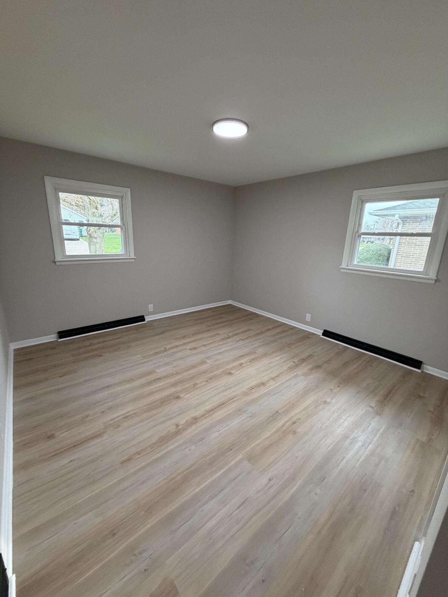 603 West 13th Street La Porte, IN 46350 - Photo 12 of 18 an empty room with wooden floor and windows