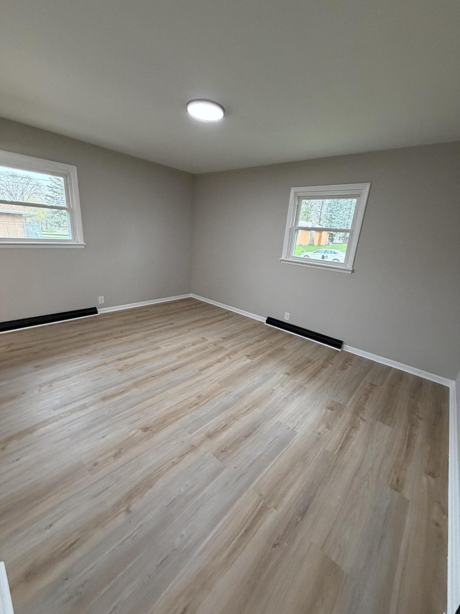 603 West 13th Street La Porte, IN 46350 - Photo 15 of 18 an empty room with wooden floor and windows