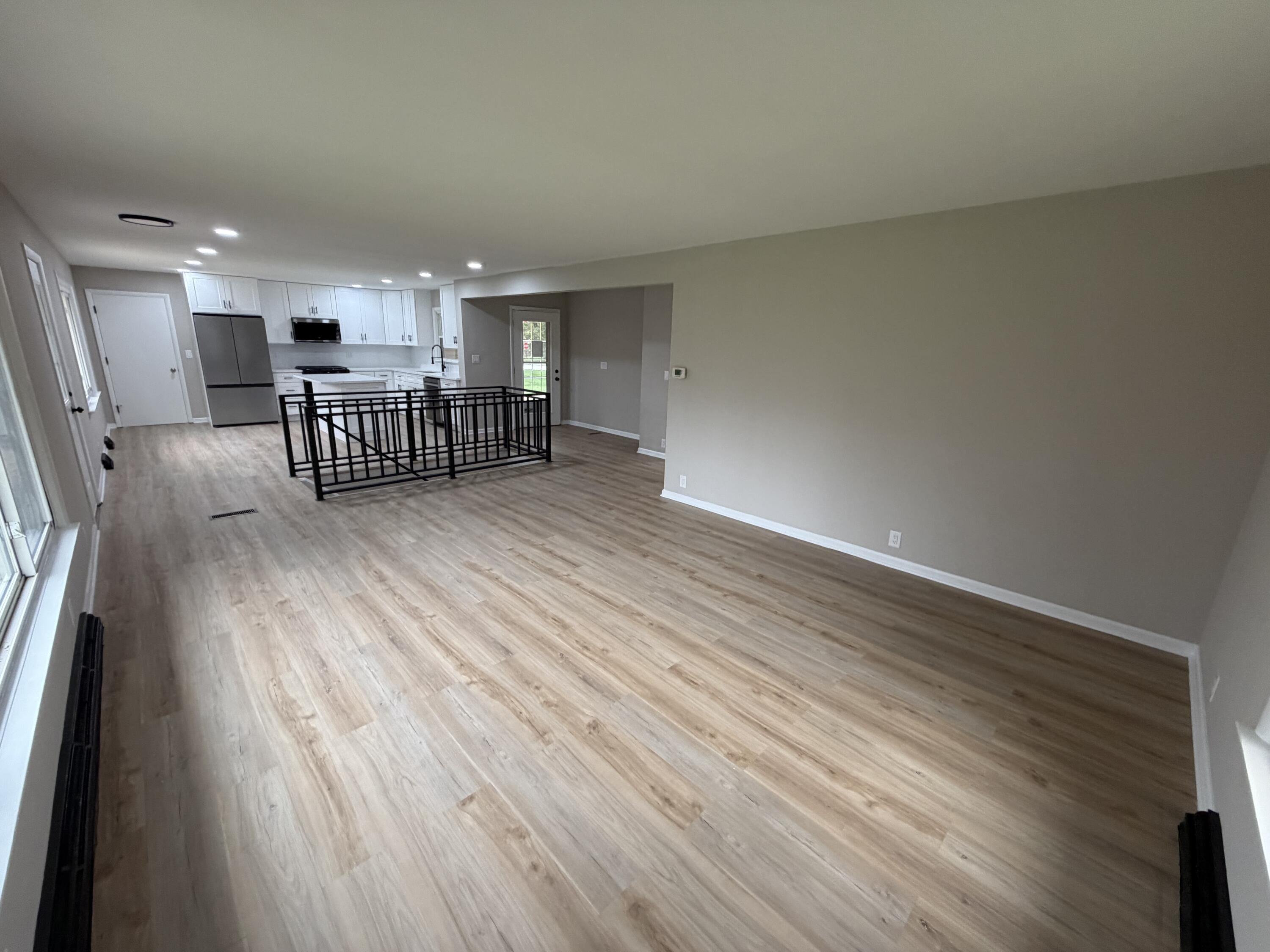 603 West 13th Street La Porte, IN 46350 - Photo 7 of 18 an empty room with wooden floor and windows