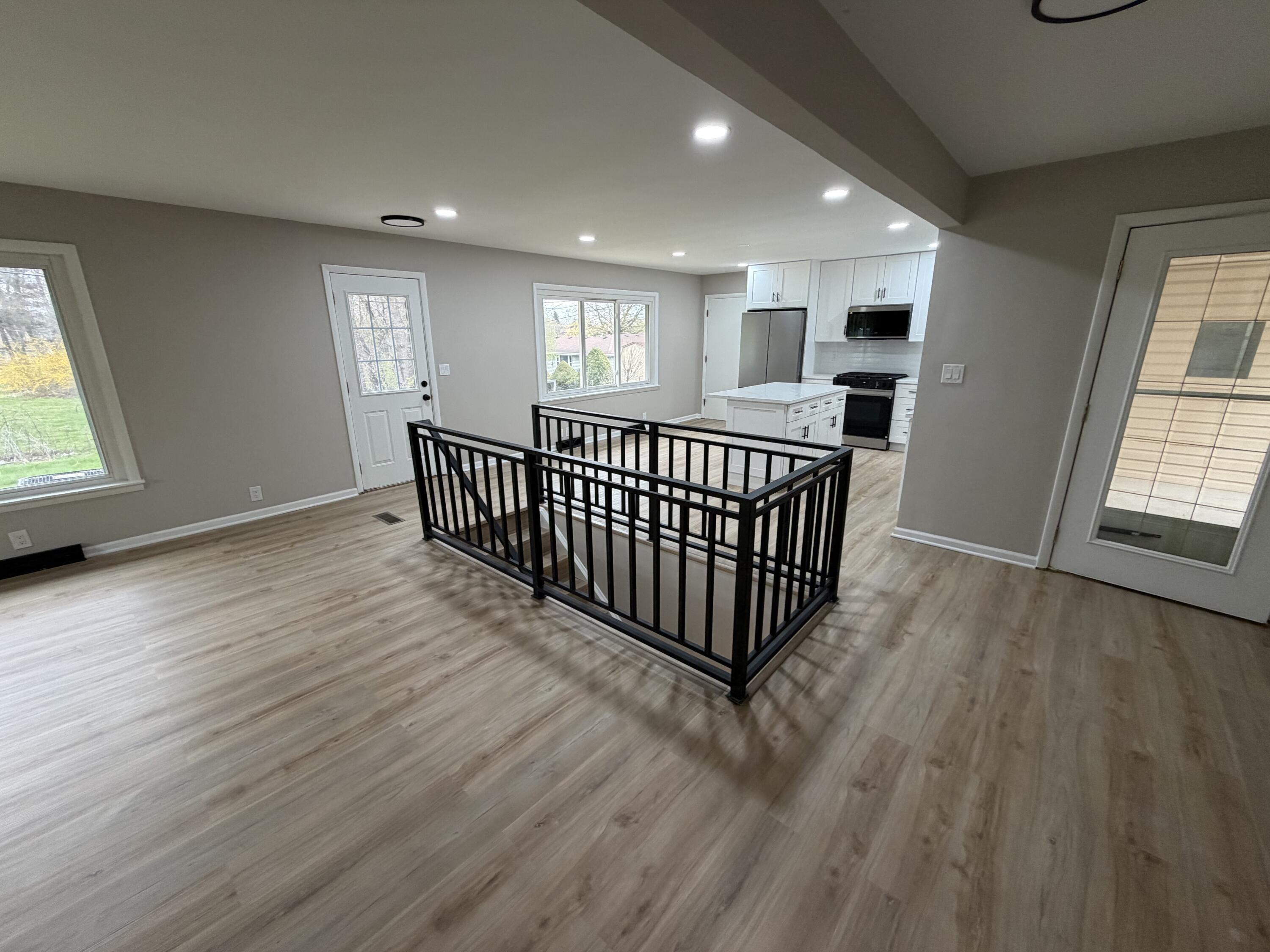 603 West 13th Street La Porte, IN 46350 - Photo 8 of 18 an empty room with wooden floor and windows