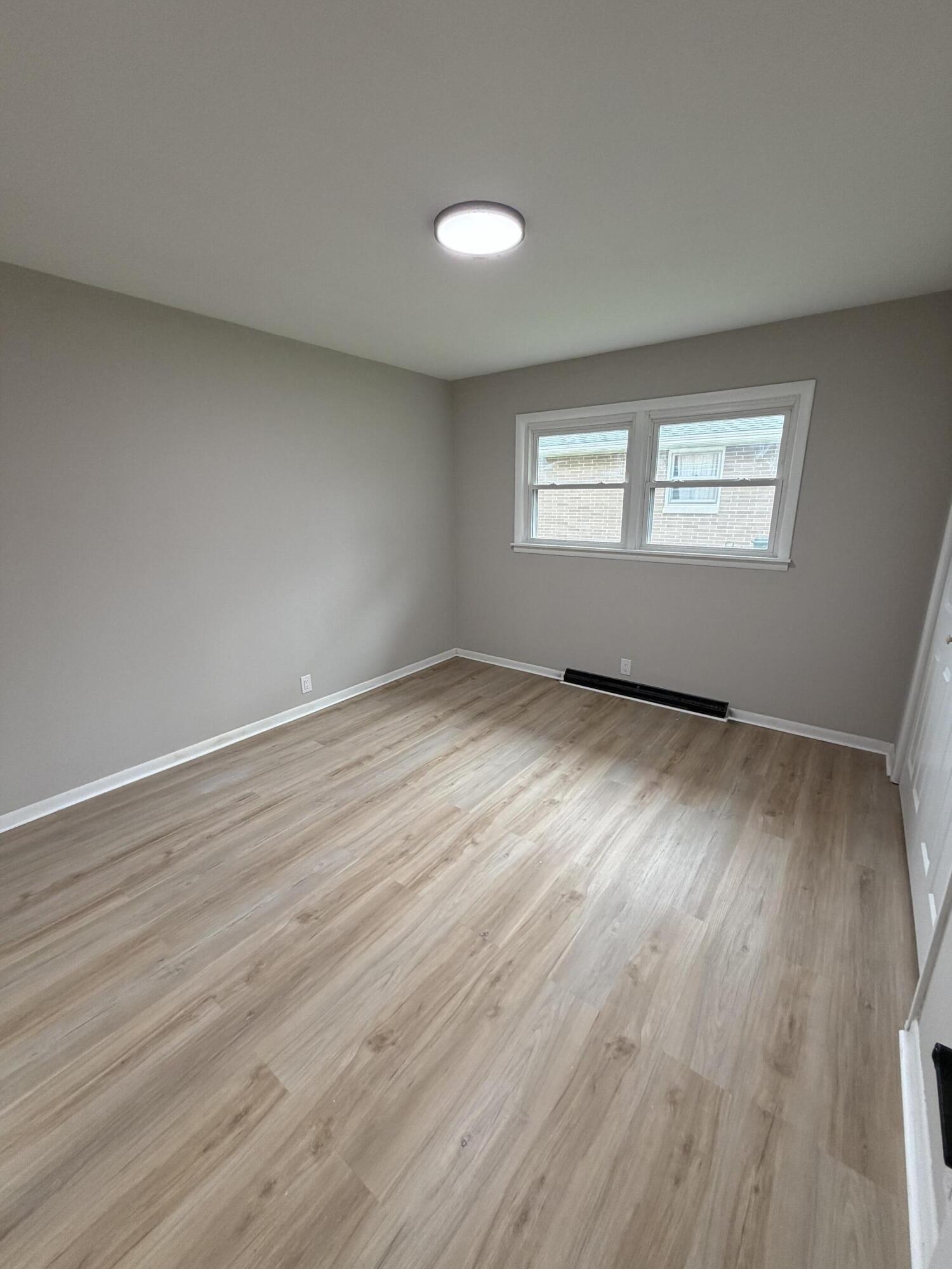 603 West 13th Street La Porte, IN 46350 - Photo 9 of 18 an empty room with wooden floor and windows