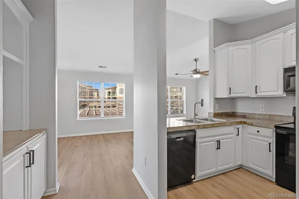 a view of a kitchen with a sink cabinets and wooden floor