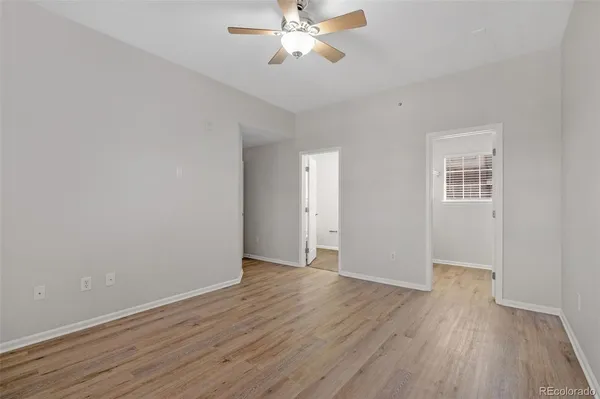 a view of an empty room with wooden floor