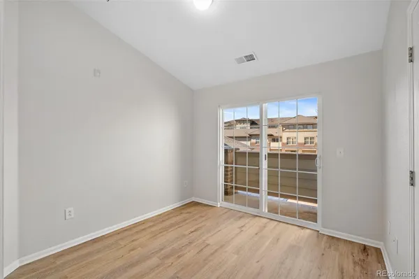 a view of wooden floor and windows in a room