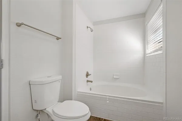 a bathroom with a toilet and shower