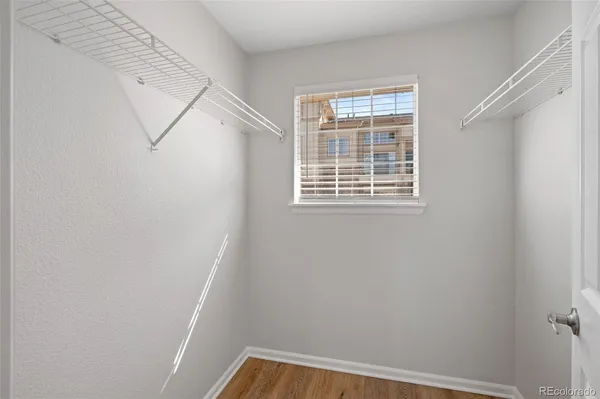 a view of a small space with window and hardwood floor