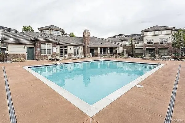 a view of a house with pool and a yard