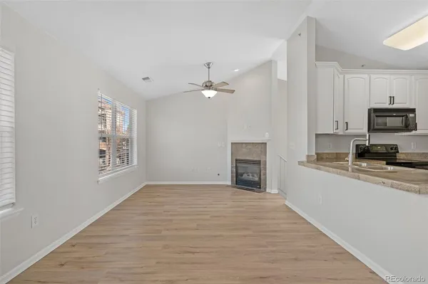 a view of kitchen with sink microwave and cabinets