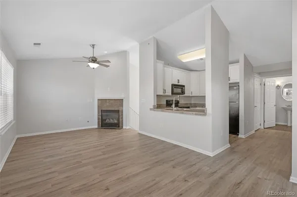 a view of a kitchen with wooden floor and a kitchen