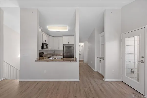 a kitchen with stainless steel appliances a refrigerator and a stove top oven