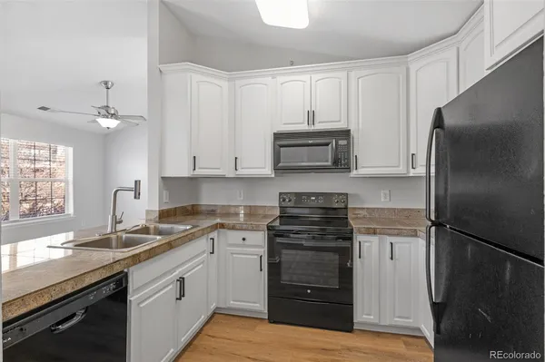 a kitchen with a sink appliances and cabinets