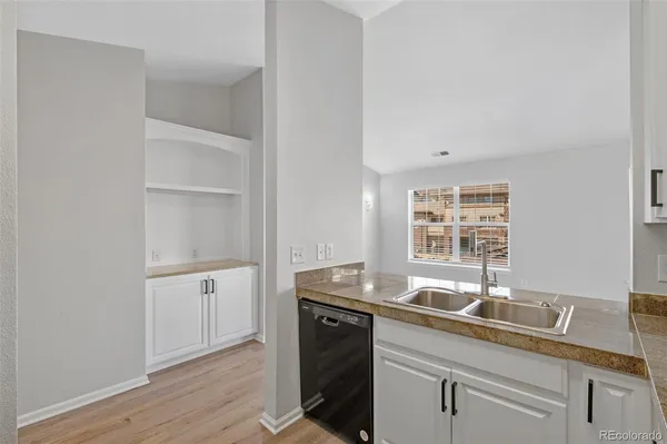 a kitchen with a sink and cabinets