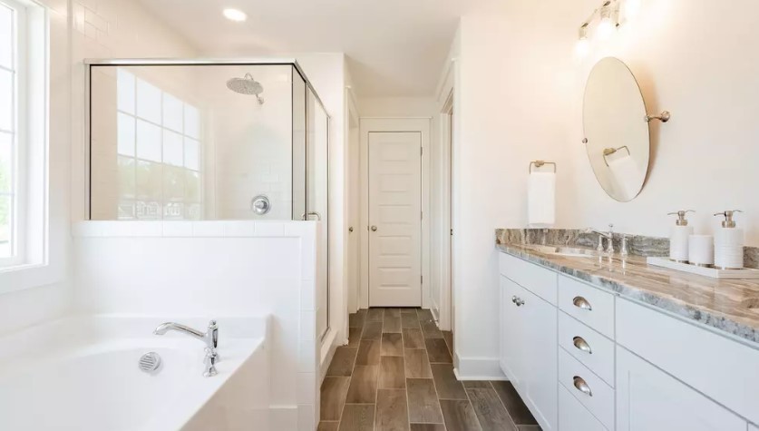 686 Conifer Dr Spring Hill Thompson's Station, TN 37179 - Photo 16 of 22 a bathroom with a granite countertop sink a mirror and a bathtub