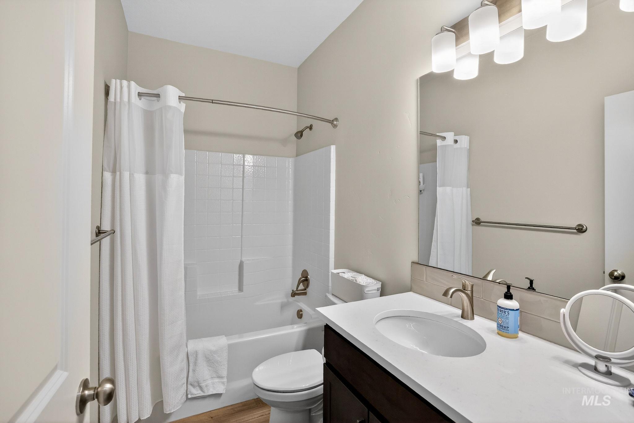 311 Broken Ridge Way McCall, ID 83638 - Photo 21 of 44 Bathroom featuring a vanity with an undermount sink, a large wall mirror, and a five-light fixture