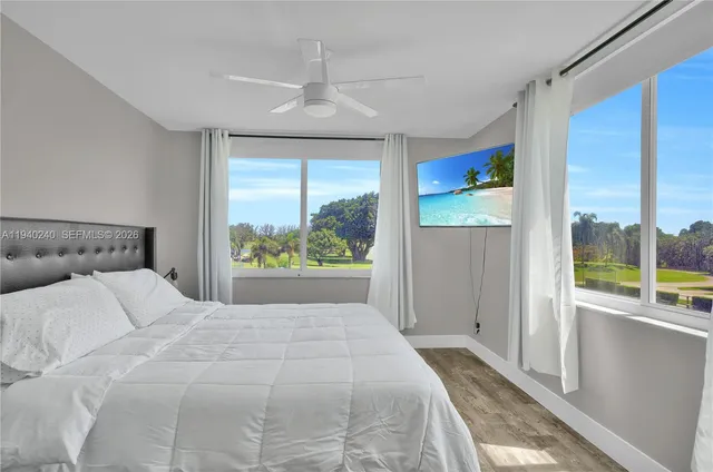 a bedroom with a large bed and a large window with outdoor views