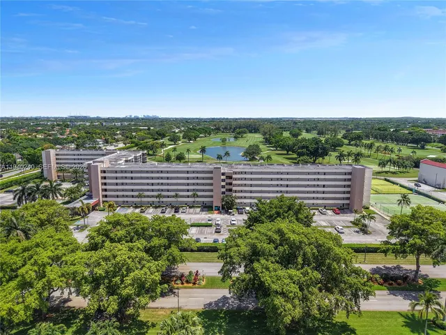 a view of a garden with lawn chairs