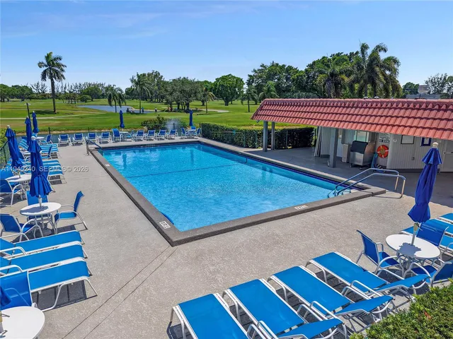 a view of a balcony with a swimming pool and outdoor seating