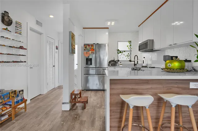 a kitchen with stainless steel appliances granite countertop a sink and cabinets