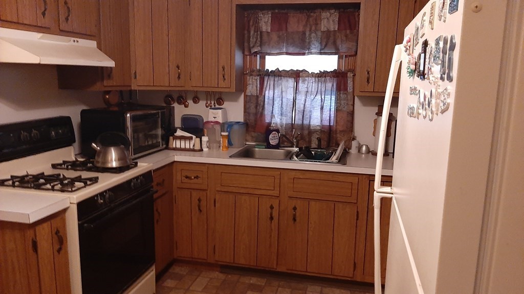 19 Glenmere Street Lowell, MA 01852 - Photo 3 of 12 a kitchen with stainless steel appliances a stove and a cabinets