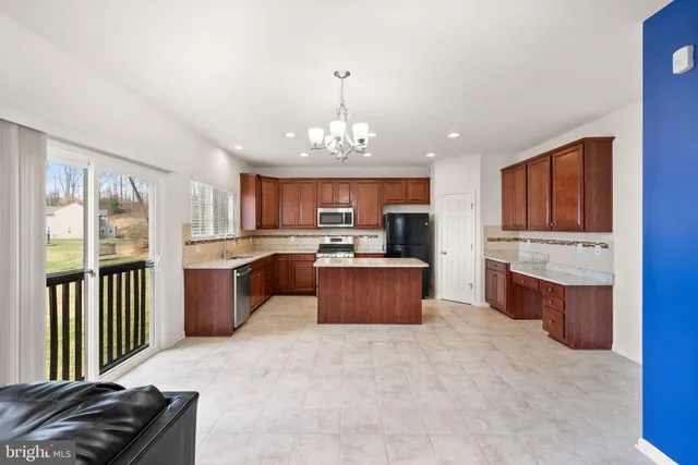 a bathroom with a granite countertop double vanity sink a mirror and a bathtub