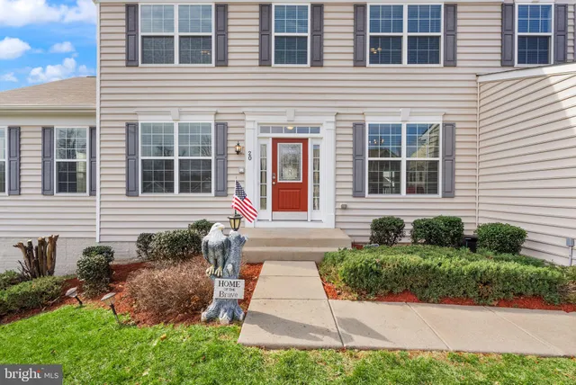 a view of hallway with furniture and a floor to ceiling window