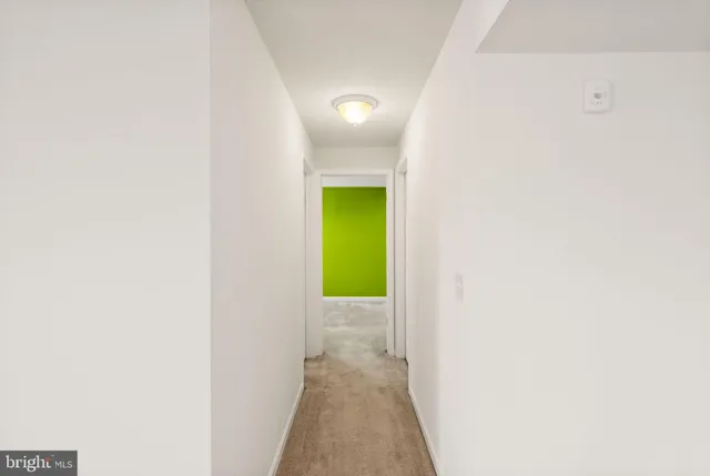 a view of a white house next to a yard