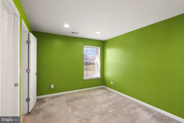 a view of a house with a big yard and large trees