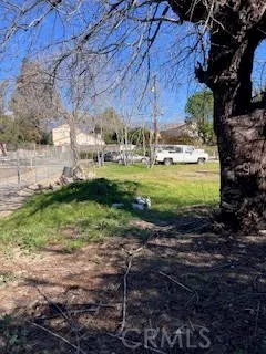 a view of a backyard with table and chairs under an umbrella
