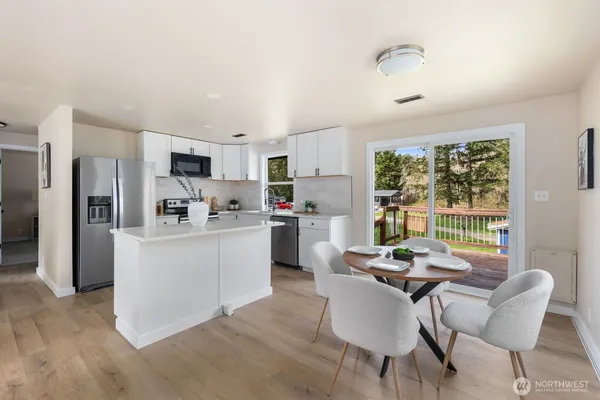 a kitchen with stainless steel appliances granite countertop a refrigerator sink and stove