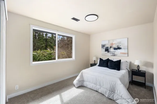 a bedroom with a bed and a window