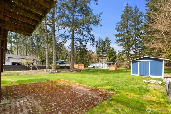 a view of a house with a yard and sitting area