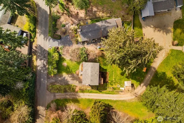 an aerial view of a house with a yard and lake view