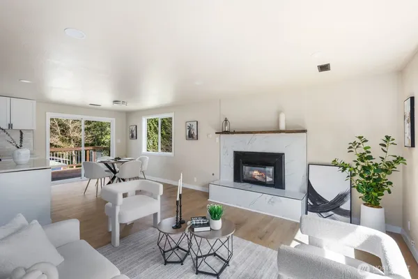 a living room with furniture wooden floor and a table