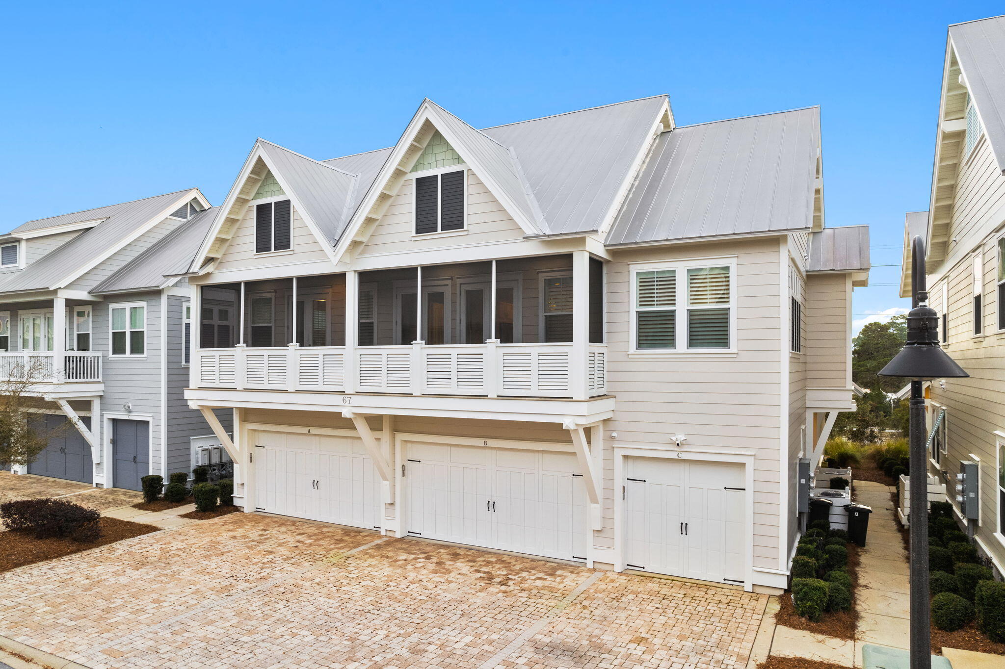 67 Milestone Dr Inlet Beach, Unit C Inlet Beach, FL 32461 - Photo 1 of 39 a view of a white house with large windows