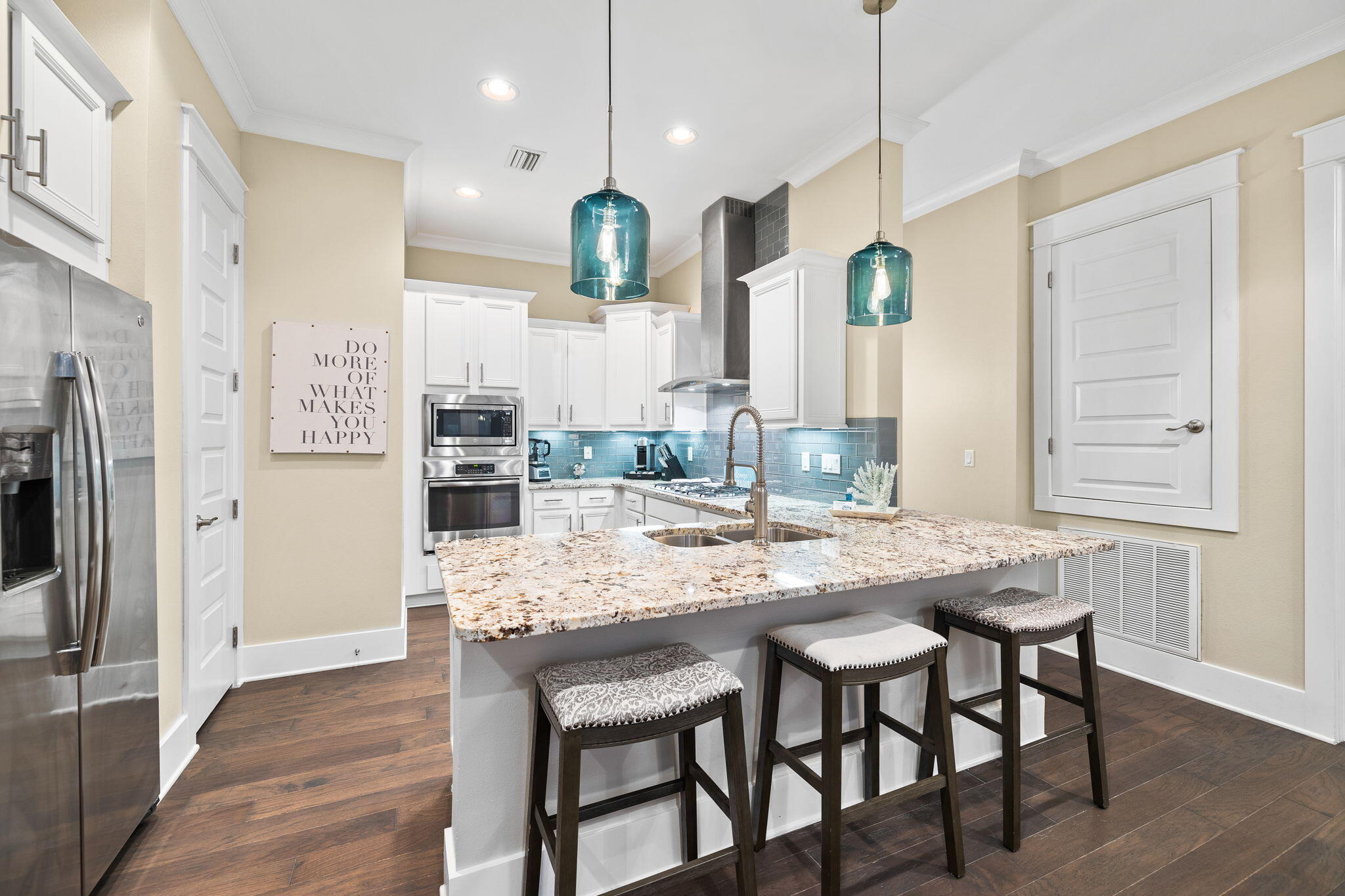 67 Milestone Dr Inlet Beach, Unit C Inlet Beach, FL 32461 - Photo 13 of 39 a kitchen with stainless steel appliances granite countertop a kitchen island and chairs in it