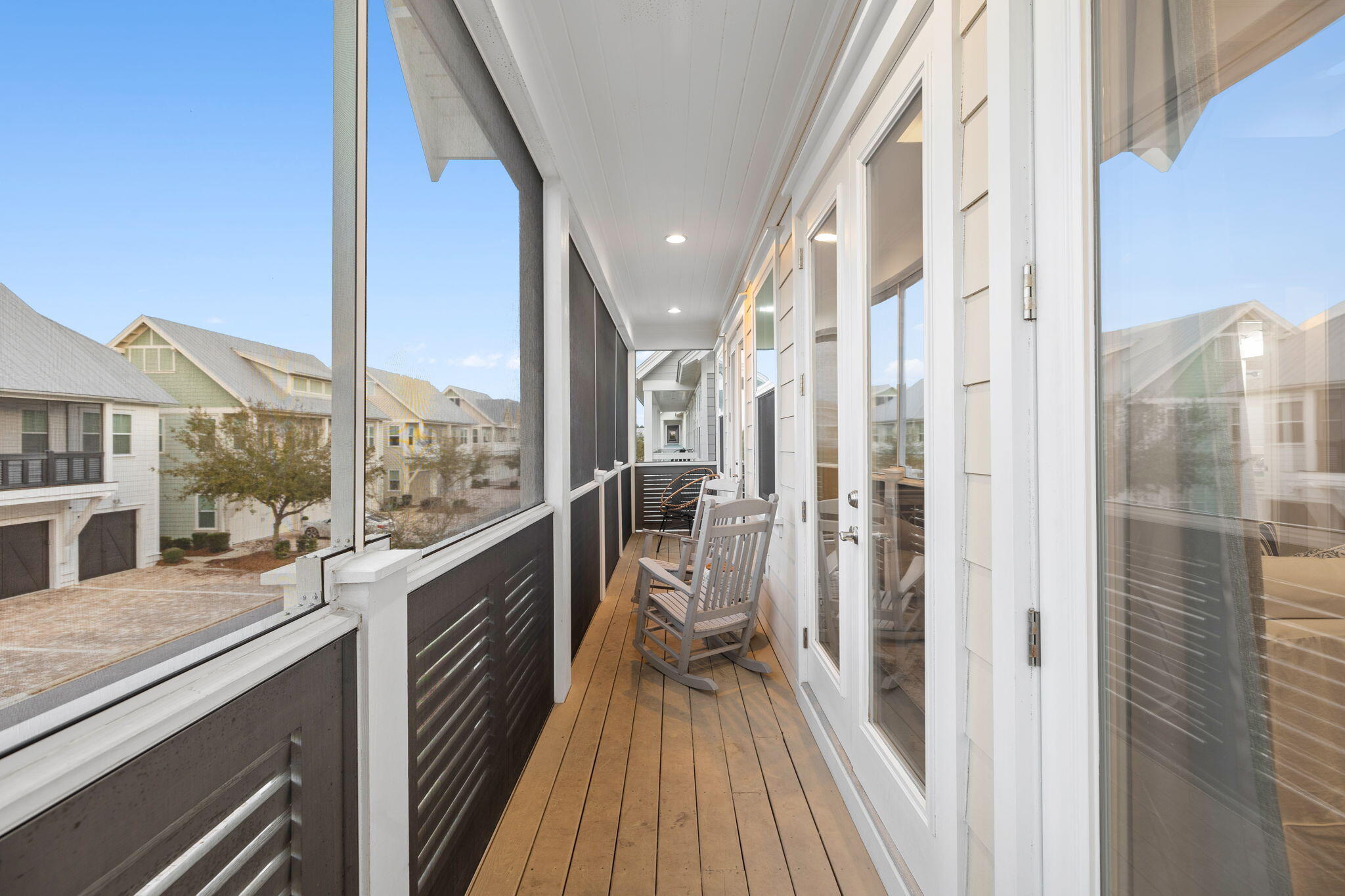67 Milestone Dr Inlet Beach, Unit C Inlet Beach, FL 32461 - Photo 23 of 39 a view of a balcony with a floor to ceiling window with wooden floor