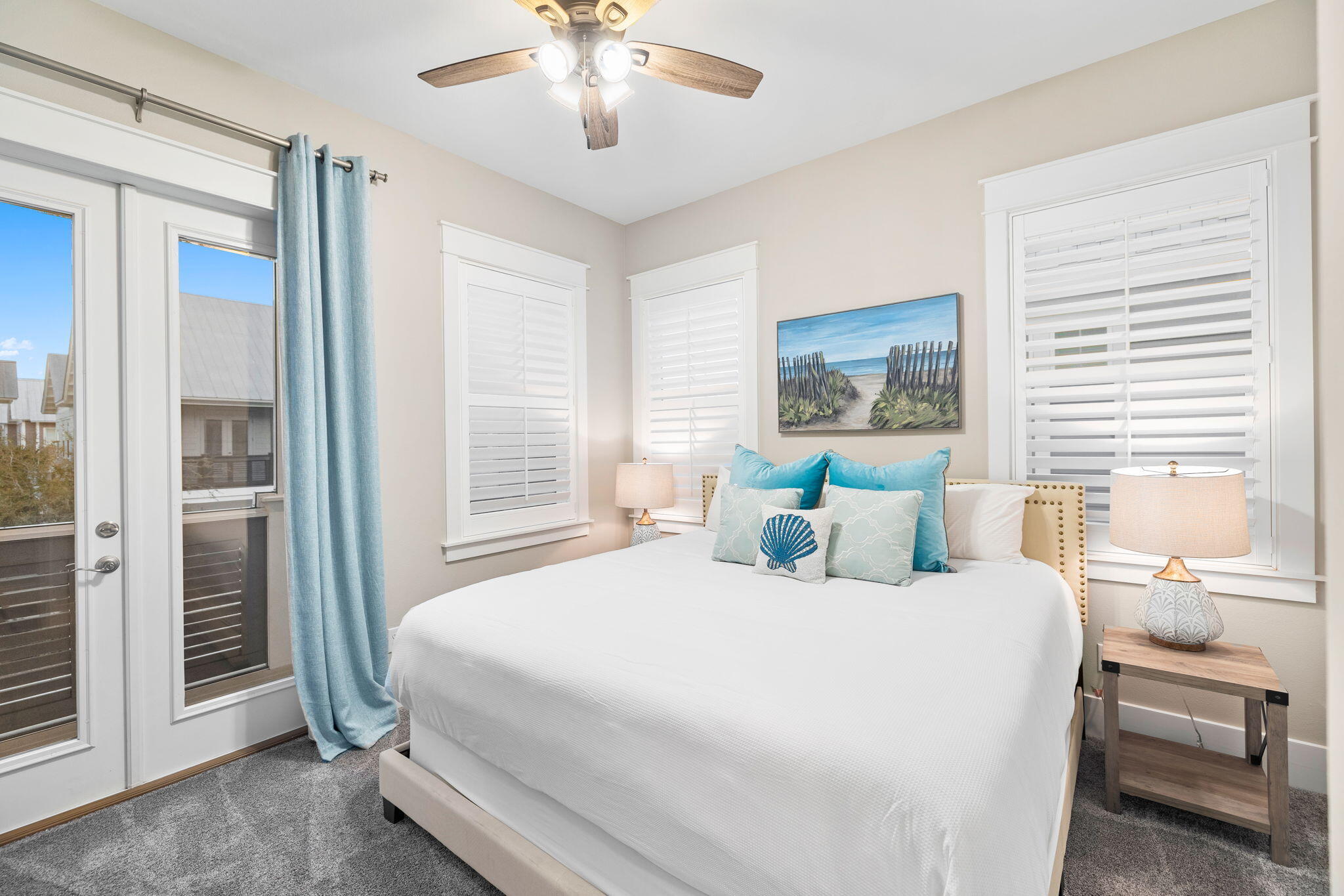 67 Milestone Dr Inlet Beach, Unit C Inlet Beach, FL 32461 - Photo 34 of 39 a bedroom with a large bed and a chandelier