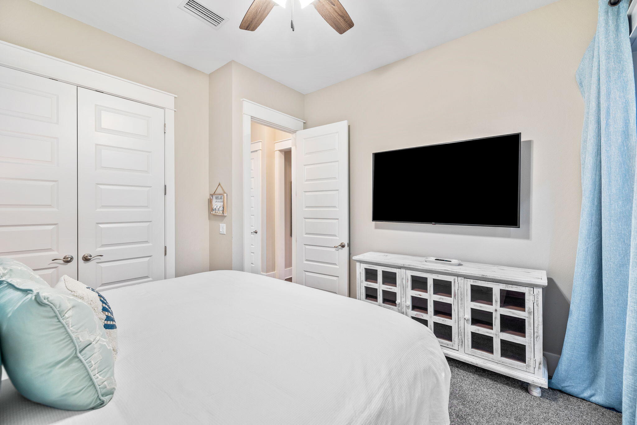 67 Milestone Dr Inlet Beach, Unit C Inlet Beach, FL 32461 - Photo 35 of 39 a bedroom with a bed and a flat screen tv