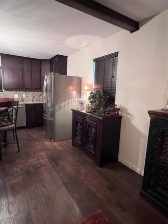 a kitchen with refrigerator and cabinets