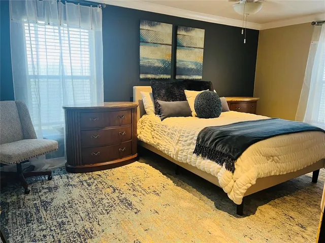 a bedroom with a bed and a window