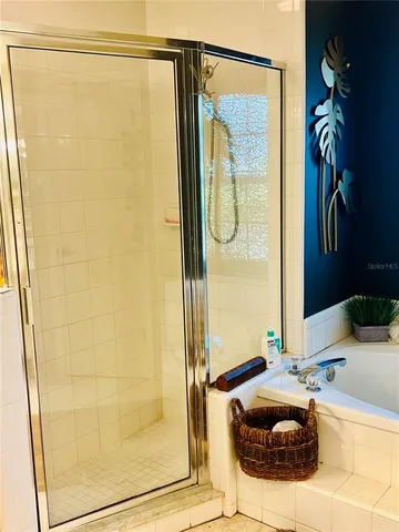 a bathroom with a tub and shower