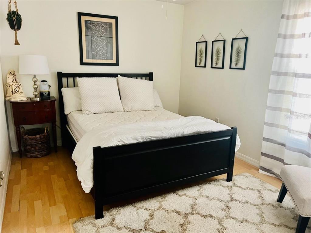 686 Park Valley Circle Minneola, FL 34715 - Photo 21 of 33 a bed sitting in a bedroom next to a mirror