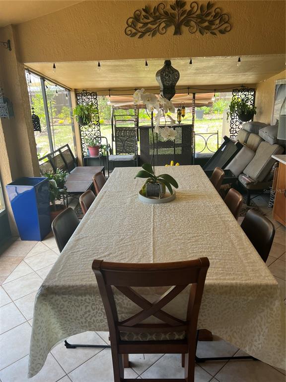 686 Park Valley Circle Minneola, FL 34715 - Photo 25 of 33 a dining room with furniture and a large window