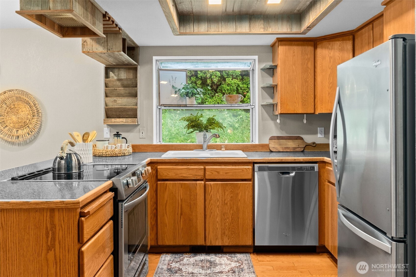 615 Clark Street Southwest Tumwater, WA 98512 - Photo 11 of 27 a kitchen with stainless steel appliances granite countertop a refrigerator a sink a stove and a refrigerator