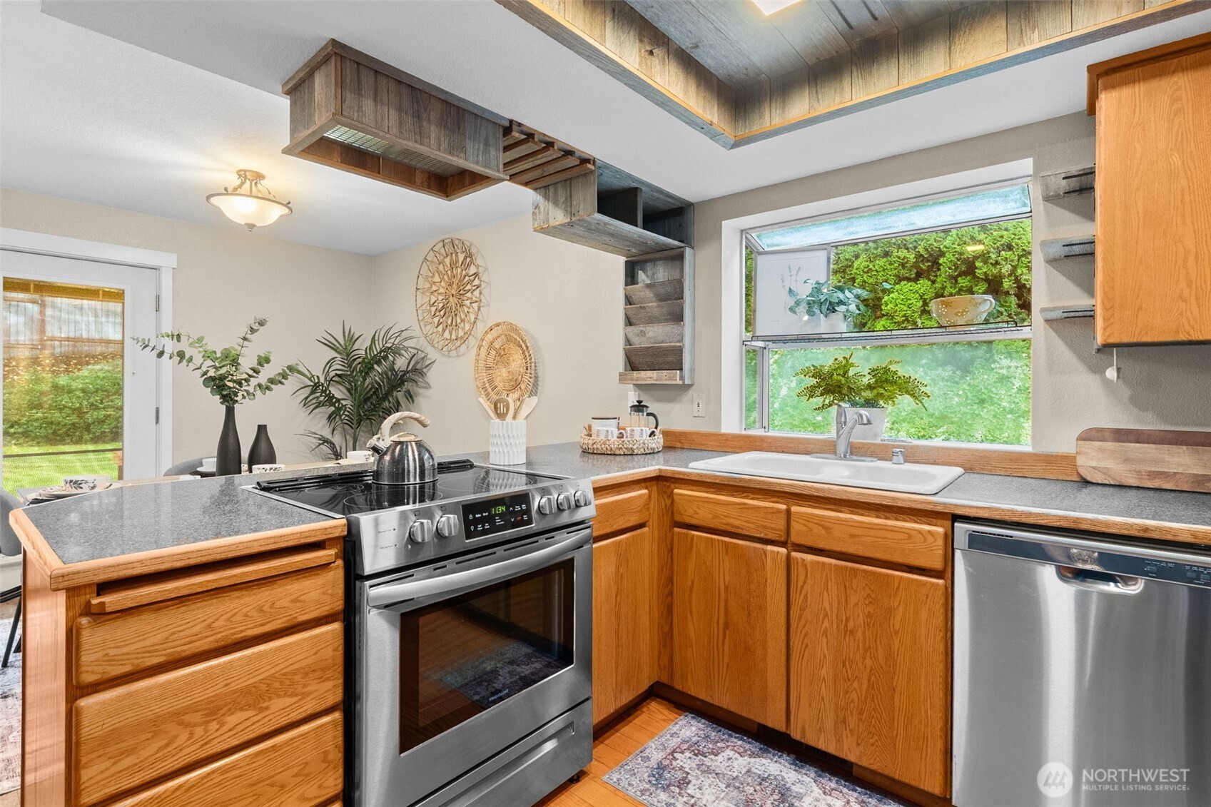 615 Clark Street Southwest Tumwater, WA 98512 - Photo 12 of 27 a kitchen with stainless steel appliances granite countertop a sink and a stove