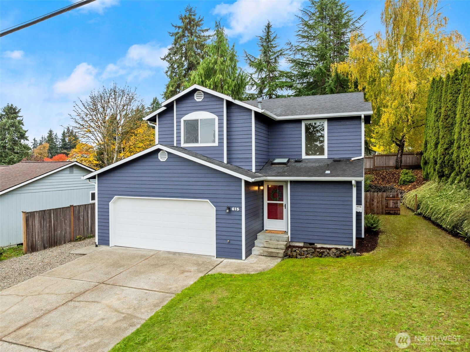 615 Clark Street Southwest Tumwater, WA 98512 - Photo 2 of 27 a front view of a house with a yard and garage