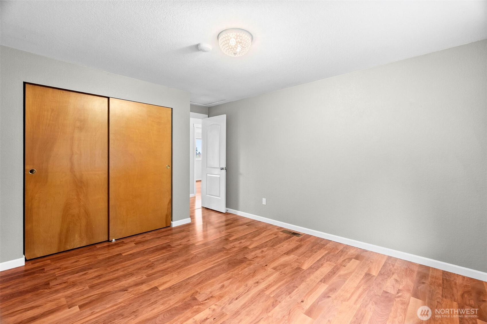 615 Clark Street Southwest Tumwater, WA 98512 - Photo 22 of 27 an empty room with wooden floor and windows